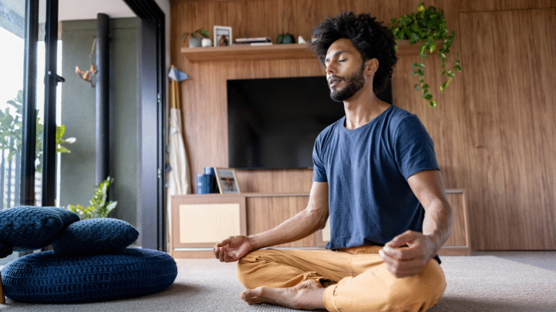A Man Meditating At Home
